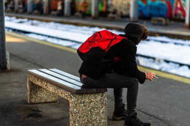 Travelers and commuters waiting for a train on the train platfor
