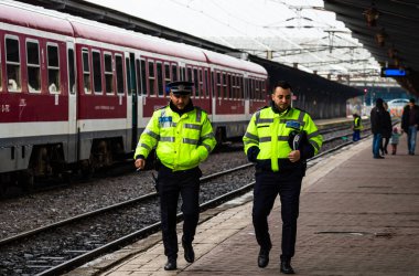 Police officers patrolling on the train platform at Bucharest No