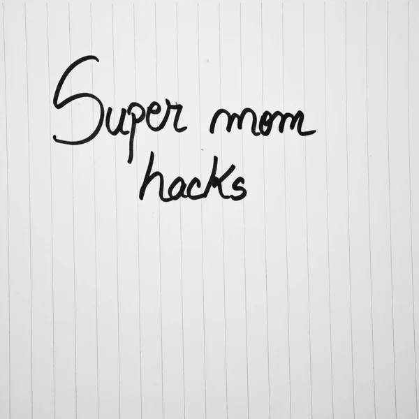 Super mom hacks writing love text for mother on paper. Label tag — 스톡 사진
