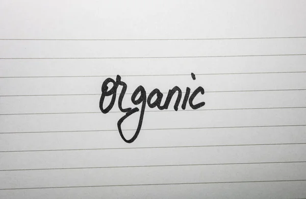 Psaní organické na bílém štítku na bílém pozadí. — Stock fotografie