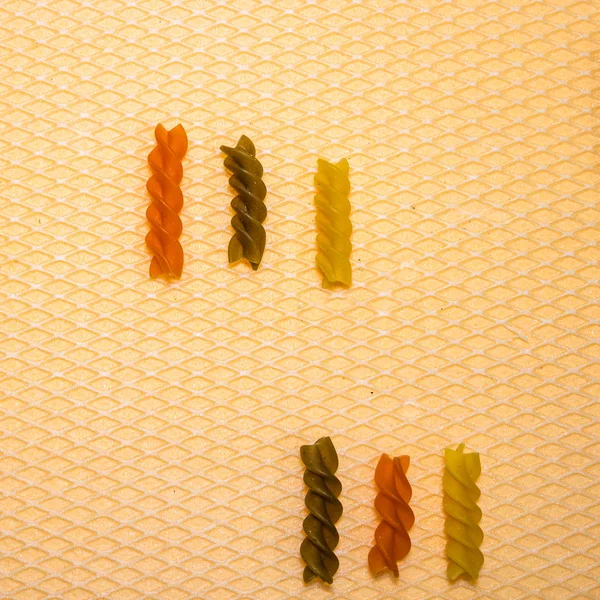 Composition of raw pasta uncooked tricolore fusilli, pasta twist