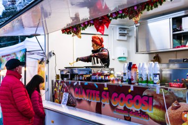 İnsanlar 2020 'de Romanya' nın Targoviste kentindeki bir yemek festivalinde gözleme ya da çörek almak için bekliyorlar..