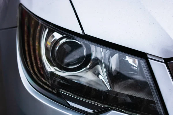 Close up photo of modern car, detail of headlight. Headlight car Projector LED of a modern luxury technology and auto detail.
