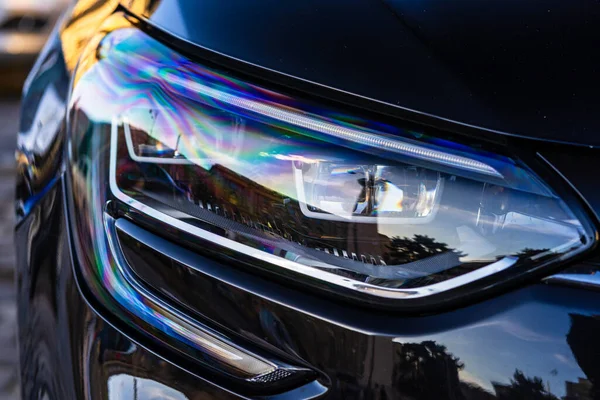 Close up photo of modern car, detail of headlight. Headlight car Projector LED of a modern luxury technology and auto detail.