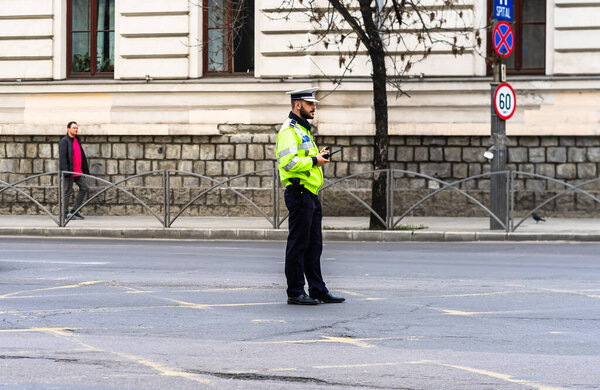Romanian Police (Politia Rutiera) directing traffic and patrolling streets to avoid curfew breaches amid the spread of the Coronavirus COVID-19 in downtown Bucharest, Romania, 2020