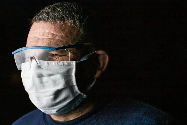 Man with protective medical mask and protective goggles. Coronavirus Covid-19 outbreak, flu contamination and healthcare concept