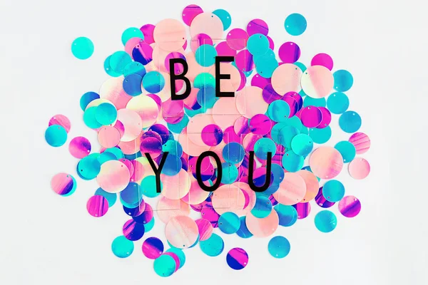 Background with shiny pink, purple and holographic sequins with words Be you, abstract background. — Stock Photo, Image