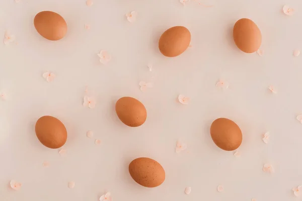 Easter eggs pattern with hydrangea flowers on beige background.