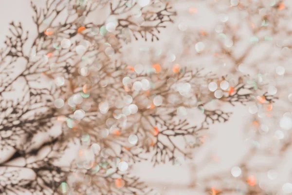 Grey botanical shadows of branches on beige wall background with golden bokeh. Abstract background. — Stockfoto