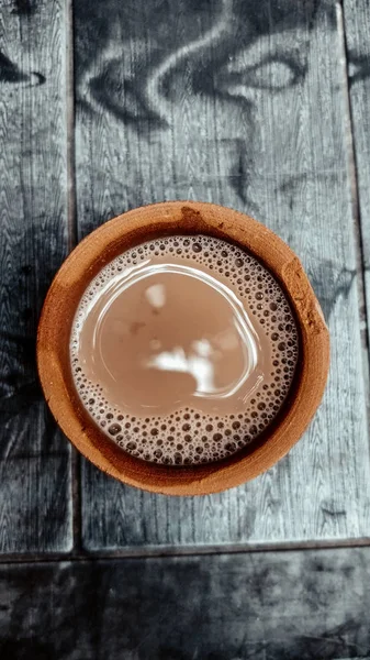 A kulhar or kulhad cup (traditional handle-less clay cup) from North India filled with hot Indian tea