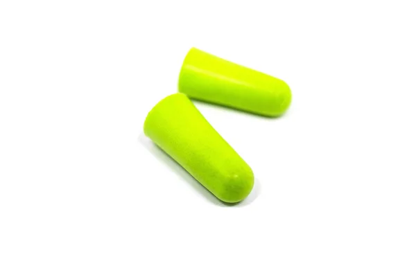 Green ear plugs close-up on a white background. Noise reduction, hearing protection. — Stockfoto