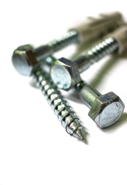 Set of screws close up. Macro photo of screws on a white background. Macro photo screws, screw background, steel screw, selective focus. — 스톡 사진