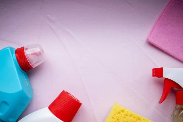 Various food and cleaning products on a pink background. Cleaning concept