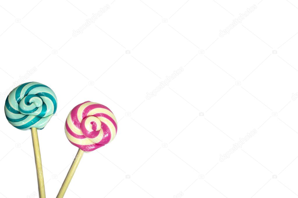 Two sweet lollipops with red, blue, turquoise and white spiral color stripes on a wooden stick isolated on a white background. Holiday card. Birthday concept, place for text.