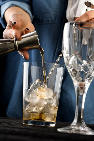 bartender preparing whiskey sour cocktail