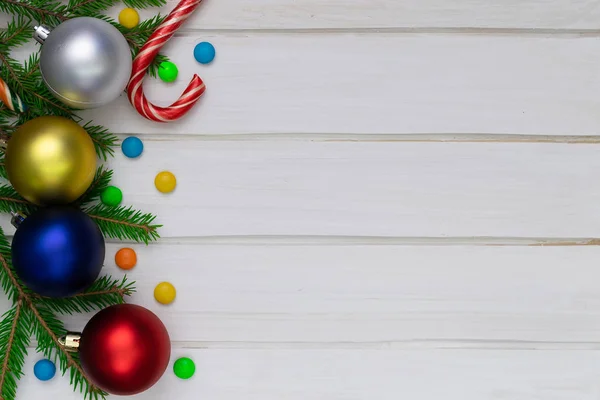 Christmas back,ground, green fir branches, red and blue, yellow, ball, candies, white boards