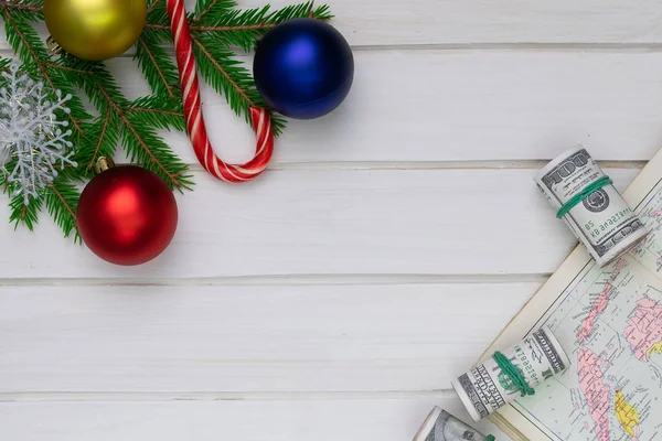 Christmas back,ground, green fir branches, red and blue ball, candies, money roll, white boards, map, old, travel holidays