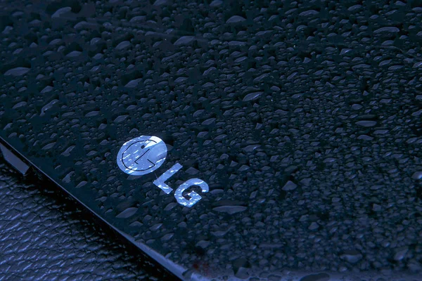 stock image Penza, RUSSIA, 17 February 2019: Korean company LG logo on black background with water drops