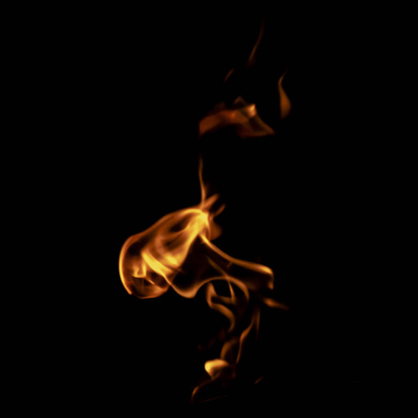 Yellow fire on black background texture isolated