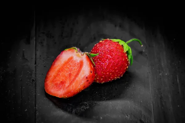 strawberry on a black wooden background