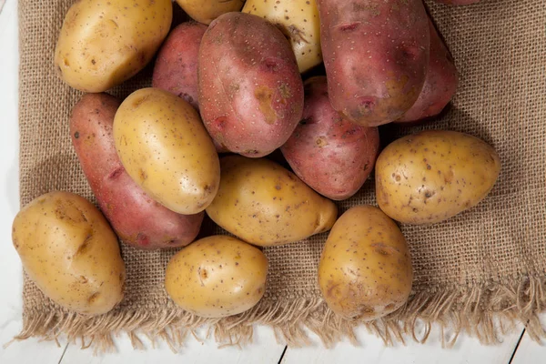 Kartoffeln auf weißem Holzgrund — Stockfoto