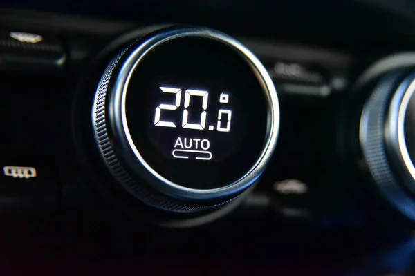 buttons to activate the air conditioning in the car and the temperature gauge