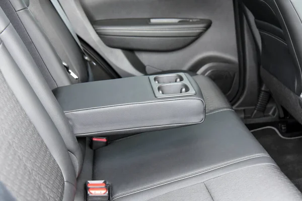 armrest in the car with cup holder for rear seats row