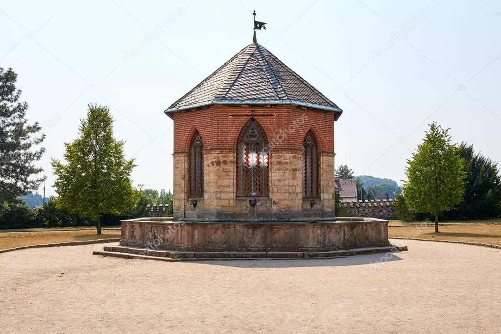 CZECH REPUBLIC,SYCHROV - AUGUST 9, 2015: Fountain near Neo Gothic castle Sychrov. Castle (chateau) with pink facade and beautiful park in english style. Liberec Region, Bohemian Paradise, Europe