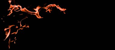 Flames of fire on a black background. The mystery of fire. clipart