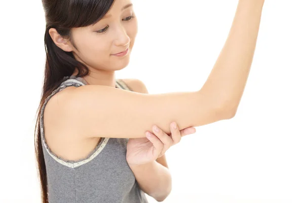 Woman checking her upper arm — Stock Photo, Image