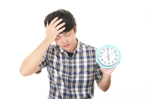Asian man with a clock — Stock Photo, Image