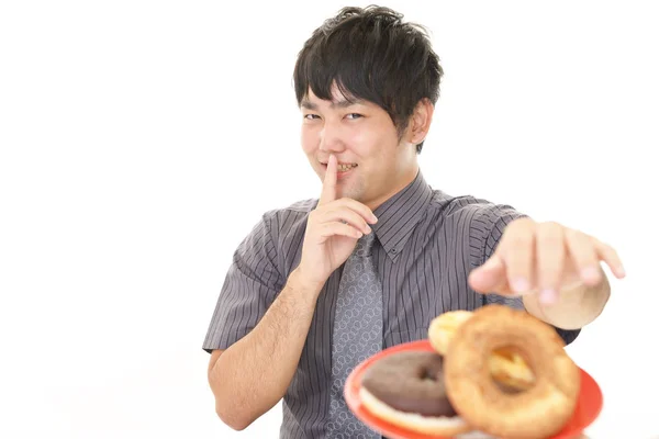 Man eating sweets — Stock Photo, Image