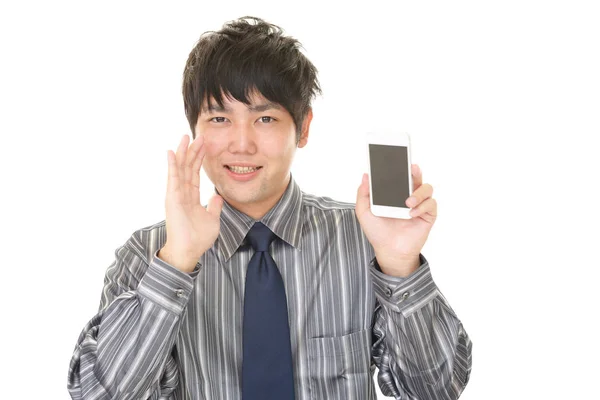 Empresario sosteniendo un teléfono inteligente — Foto de Stock