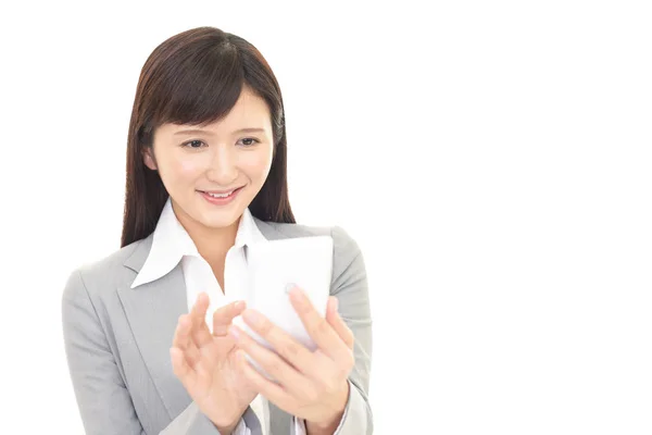 Business woman looking at smart phone — Stock Photo, Image