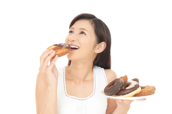Woman eating sweets — Stock Photo, Image