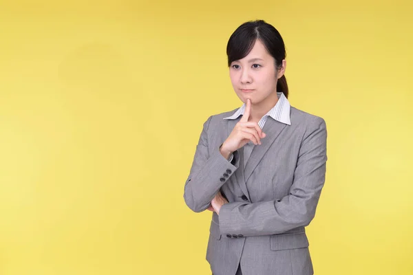 Uneasy Asian business woman — Stock Photo, Image