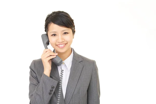 Mulher de negócios com um telefone — Fotografia de Stock