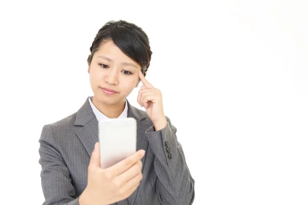 Uneasy Asian business woman — Stock Photo, Image