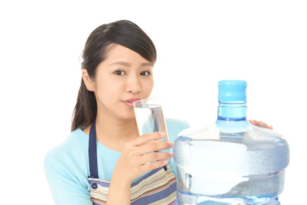 Woman drinking a glass of water — Stock Photo, Image