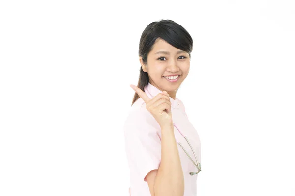 Ung kvinnlig sjuksköterska pekar — Stockfoto