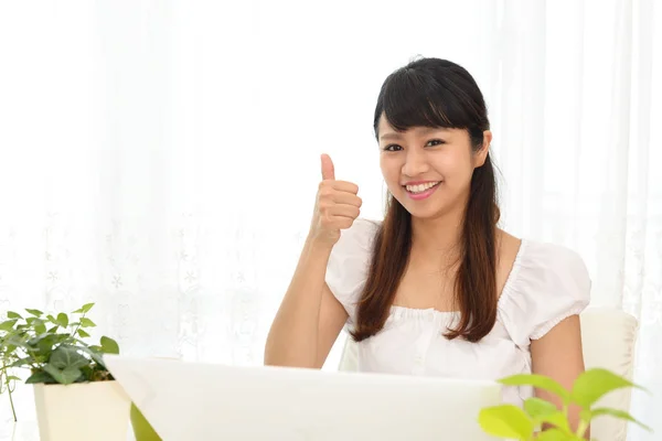 Mulher sorridente usando um laptop — Fotografia de Stock