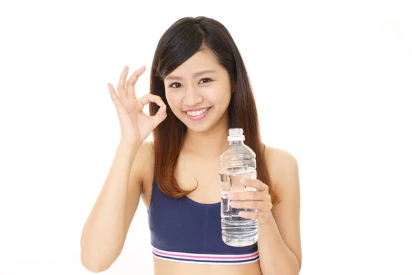 Woman drinking a bottle of water — Stock Photo, Image