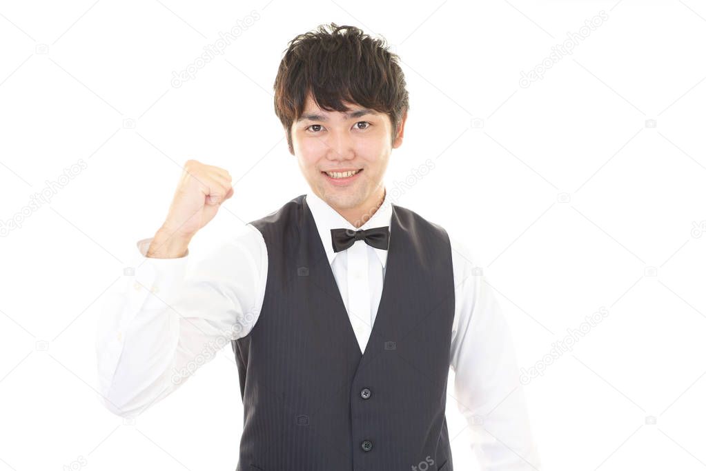Smiling Asian waiter isolated on white background
