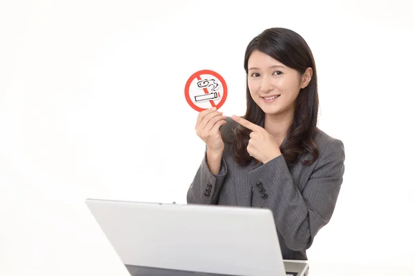 Woman holds non smoking sign