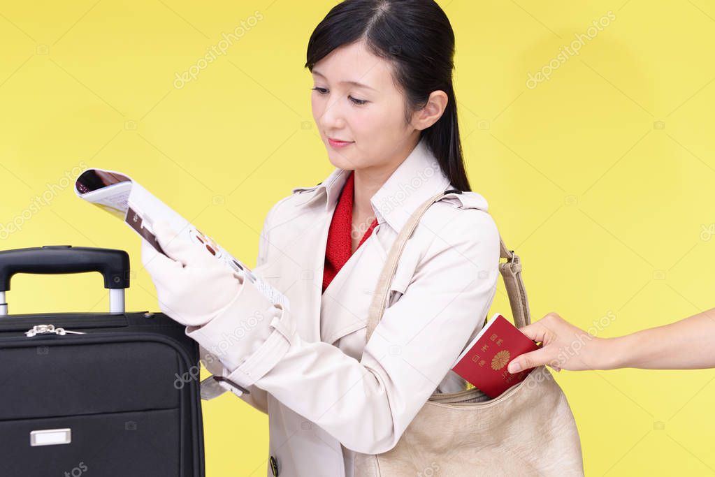 Thief stealing a passport from the women's bag