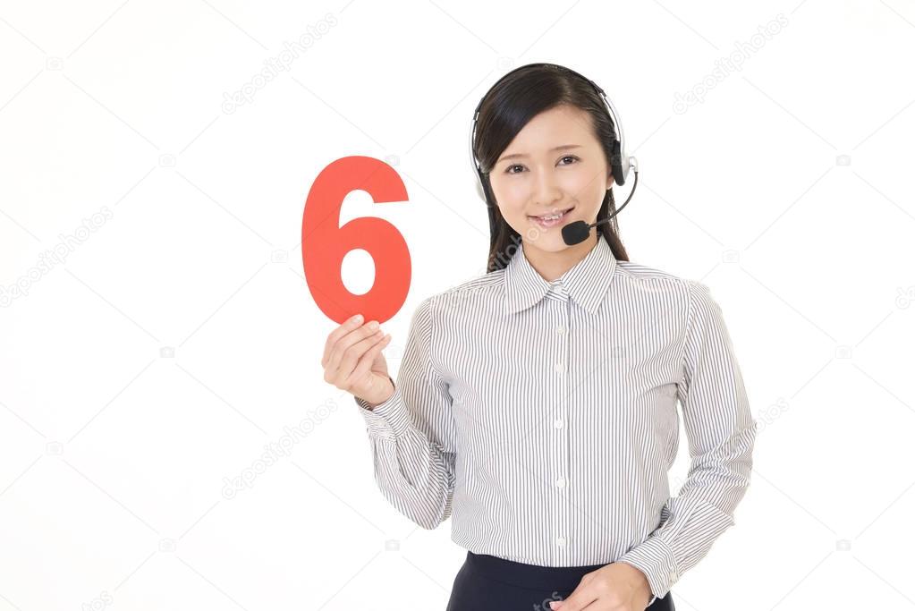 Smiling call center operator with a number