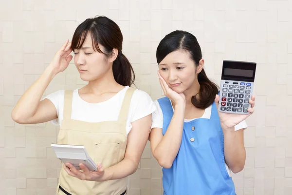 Disappointed women with calculator