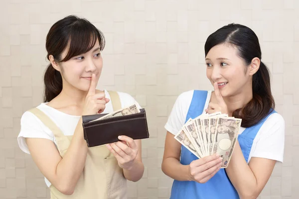 Smiling women with money