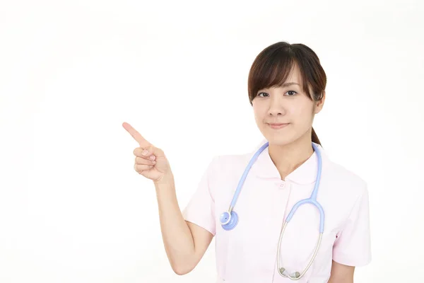 Pielęgniarka Kobiece Wskazując Jej Palcem — Zdjęcie stockowe