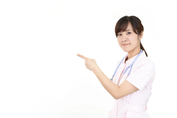 그녀의 손가락으로 가리키는 아시아 간호사 — 스톡 사진